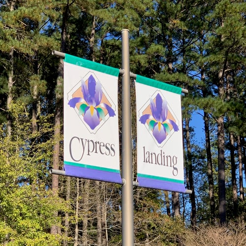 Entrance flags at Cypress Landing community in Chocowinity, NC – A premier waterfront neighborhood with homes, marina, and golf club.